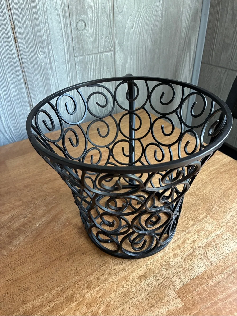 wrought iron decorative basket shaped like a large coffee mug or teacup,